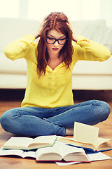 Image showing smiling student girl reading books at home