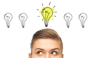 Image showing close up of woman looking to lighting bulbs