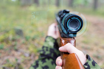 Image showing close up of soldier or sniper with gun in forest