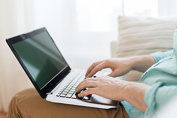 Image showing close up of man working with laptop at home