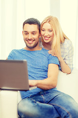 Image showing smiling happy couple with laptop at home