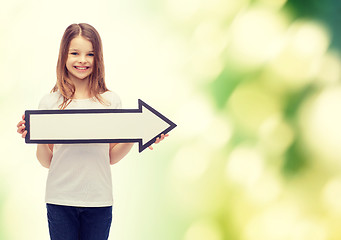 Image showing smiling girl with blank arrow pointing right