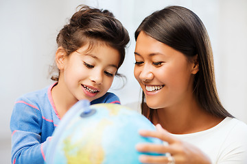 Image showing mother and daughter with globe