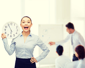 Image showing attractive businesswoman with wall clock