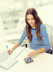 Image showing student girl with book, calculator and notebook