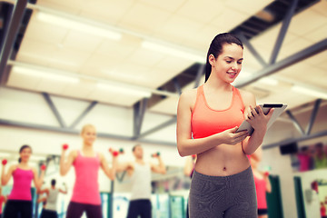 Image showing sporty woman with tablet pc computer