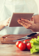 Image showing closeup of man pointing finger to tablet pc