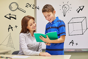 Image showing school boy with notebook and teacher in classroom