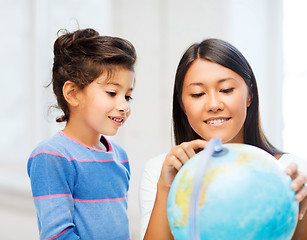 Image showing mother and daughter with globe