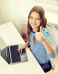Image showing smiling teenage gitl with laptop computer at home