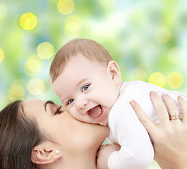 Image showing happy mother with baby over green background