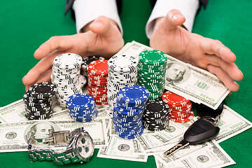 Image showing poker player with chips and money at casino table