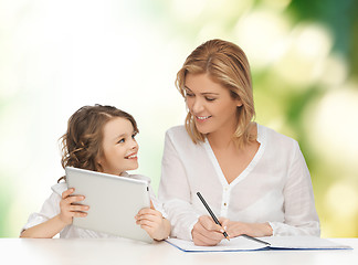 Image showing woman with notebook and girl holding tablet pc 