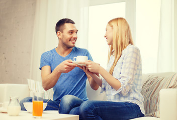 Image showing man giving his girlfriend or wife cup of coffee