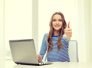 Image showing smiling teenage gitl with laptop computer at home