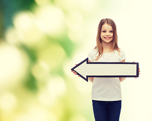 Image showing smiling girl with blank arrow pointing left