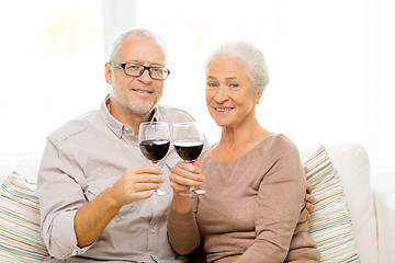 Image showing happy senior couple with glasses of red wine