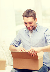 Image showing man with cardboard boxes at home