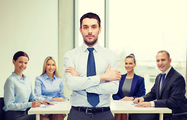 Image showing handsome businessman with crossed arms