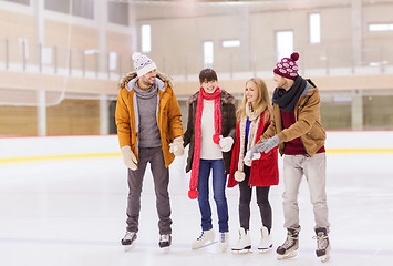 Image showing happy friends on skating rink