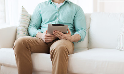 Image showing close up of man with tablet pc computer at home