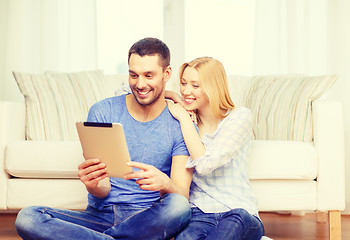 Image showing smiling happy couple with tablet pc at home