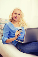 Image showing smiling woman with laptop computer and credit card