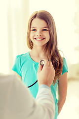 Image showing male doctor with stethoscope listening to child