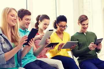 Image showing smiling students with tablet pc at school