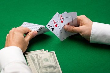 Image showing poker player with cards and money at casino