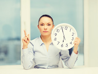 Image showing attractive businesswoman with white clock