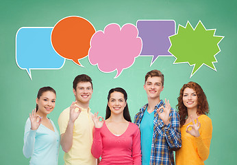 Image showing group of smiling teenagers with text bubble
