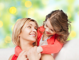Image showing happy mother with daughter hugging and talking