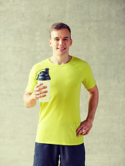 Image showing smiling man with protein shake bottle