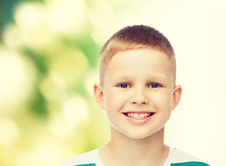 Image showing smiling little boy over green background