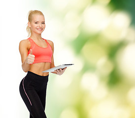 Image showing smiling sporty woman with tablet pc computer