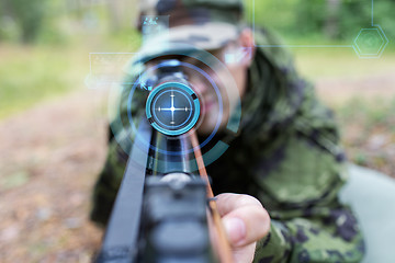 Image showing close up of soldier or sniper with gun in forest