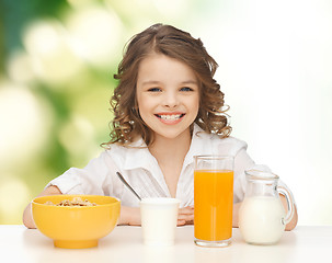 Image showing happy girl eating healthy breakfast