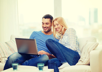 Image showing smiling happy couple with laptop at home