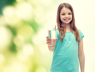 Image showing smiling little girl giving glass of water