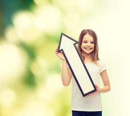 Image showing smiling little girl with blank arrow pointing up