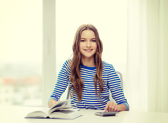 Image showing student girl with book, calculator and notebook