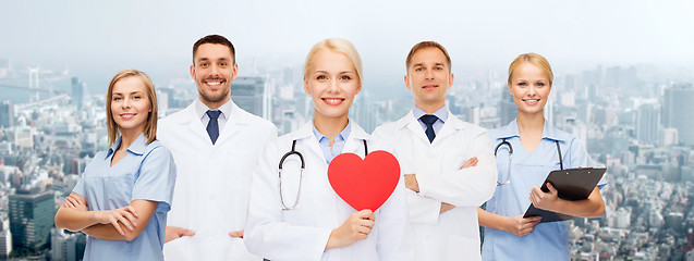 Image showing group of smiling doctors with red heart shape