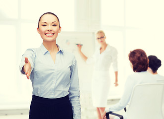 Image showing businesswoman with opened hand ready for handshake