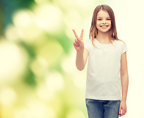 Image showing little girl in white t-shirt showing peace gesture