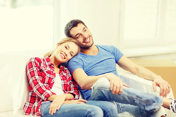 Image showing smiling couple relaxing on sofa in new home