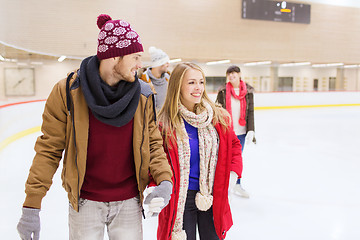 Image showing happy friends on skating rink