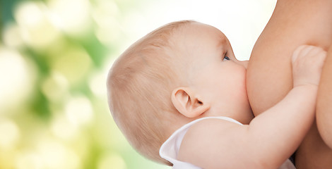 Image showing close up of mother breast feeding adorable baby