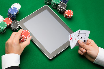 Image showing casino poker player with cards, tablet and chips