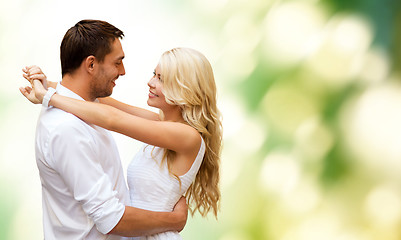 Image showing happy couple hugging over green background